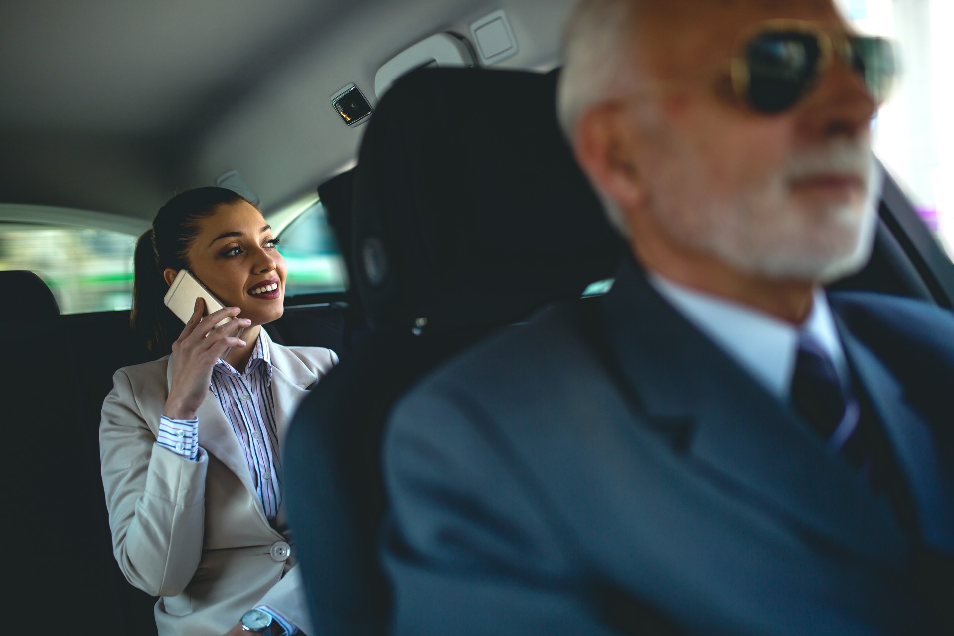 Beautiful business woman is working in car